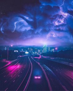 a car driving down a highway under a cloudy sky with lightning in the distance and city lights behind it