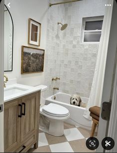 a bathroom with a toilet, sink, and bathtub in the middle of it