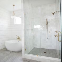 a bathroom with a tub, sink and shower head in the middle of the room