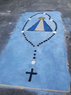 a blue and white painted area with a cross on the ground next to it,