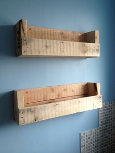 two wooden shelves mounted to the side of a wall