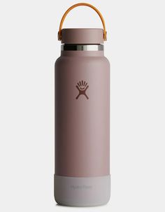 the hydro flask water bottle is shown in dusty pink with an orange rubber handle