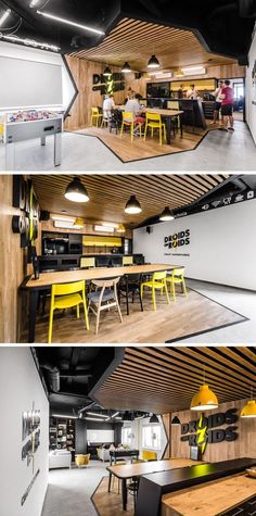 the inside of a restaurant with wooden tables and yellow chairs, while people sit at their desks