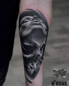 a man with a skull tattoo on his arm