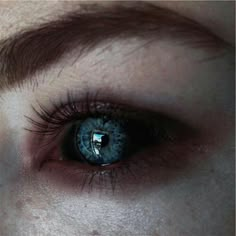 a close up of a person's blue eye