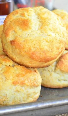 some biscuits are stacked on top of each other in a metal pan and ready to be eaten