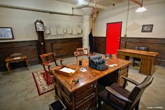 an old fashioned desk and chairs in a room