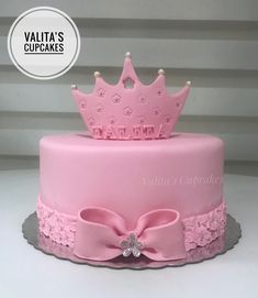 a pink cake with a crown on top