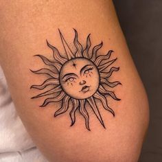 a sun with a sleeping face tattoo on it's leg and the moon behind it