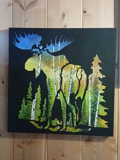 the moose is walking through the woods with pine trees on it's back side