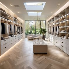 a large walk in closet with lots of clothes