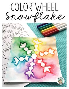 the color wheel snowflake is shown with markers and crayons on it