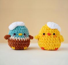 two small crocheted birds sitting next to each other