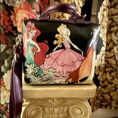 A Disney Parks Exclusive Purse Featuring Ariel, Aurora, And Snow White. It Has Handles And An Adjustable Detachable Shoulder Strap. A Zippered Compartment Inside Never Used. Man Made Material 9”H D 4” D X 8” W Jack Skellington Bag, Tiki Room Disney, Mickey Mouse Backpack, Minnie Ears Headband, Mini Crossbody Purse, Disney Bags, Pandora Disney, Small Cosmetic Bags, Disney Bag