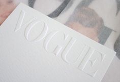 a close up of the word voug written in white paper