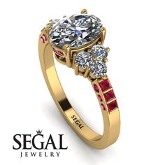 a yellow gold engagement ring with three stones on the side and an inscription segel jewelry