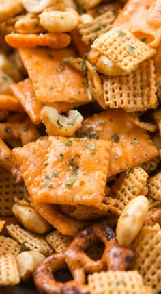 cheesy crackers and nuts are piled up in a pile on the table