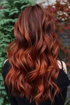 Woman with copper brunette hair styled in soft waves. Red Hair Copper Balayage, Deep Red And Copper Hair, Cherry Red And Copper Hair, Auburn With Red Highlights, Bright Red Hair With Lowlights, Copper Hair Color For Brunettes, Copper Hair Ideas For Brunettes, Multidimensional Copper Hair, Red Copper Ombre Hair