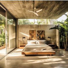 a bedroom with a large bed sitting under a ceiling fan