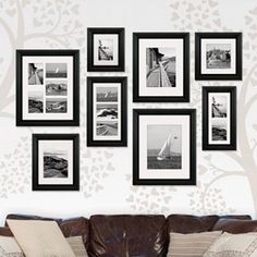 a living room filled with furniture and pictures on the wall