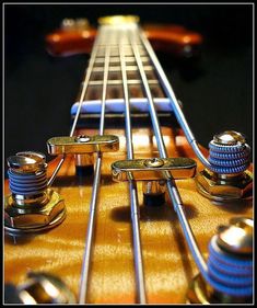 an electric guitar neck with several knobs on the fret and two strings attached to it