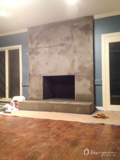 a living room that is being remodeled with blue walls and wood flooring in the foreground