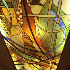 a large stained glass window hanging from the ceiling