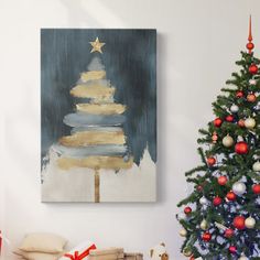 a christmas tree in front of a painting on the wall next to a pile of presents