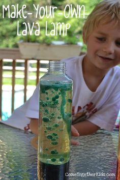 a young boy sitting at a table next to a bottle with liquid in it and the words make your own lava lamp