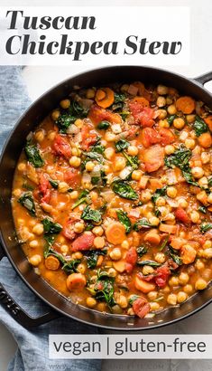 a pan filled with chickpea and spinach stew on top of a blue towel