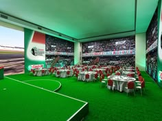 an indoor soccer field with tables and chairs set up for a game in the center