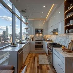 a kitchen with wood flooring and white cabinets in front of large windows overlooking the city