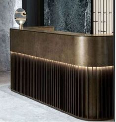 an elegant reception area with marble walls and flooring, along with a large metal sculpture