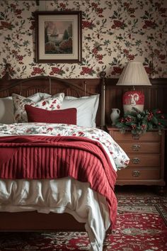 a bedroom with floral wallpaper and red bedding