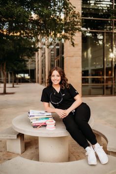 a woman sitting at a table with books