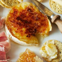 some food is laying out on a white plate with utensils and cheeses