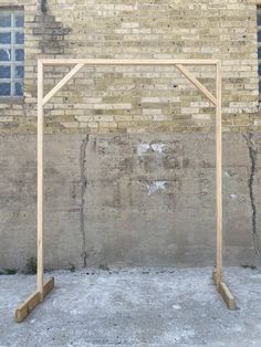 a wooden frame against a brick wall