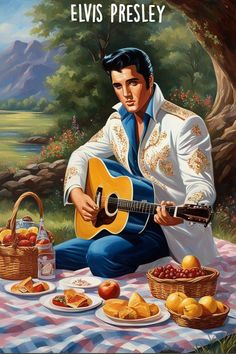 elvis presley sitting on a picnic blanket with fruit in front of him and his guitar