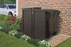 a large trash can sitting next to a brick building