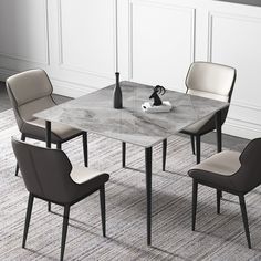 a dining table with chairs and a vase on the top, in front of a white wall