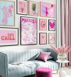 a living room filled with pink and blue art on the wall next to a couch