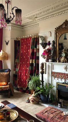 a living room filled with furniture and a fire place under a chandelier next to a fireplace