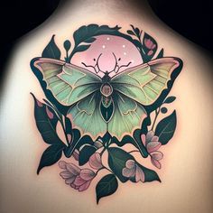 a woman's back with a butterfly tattoo on it