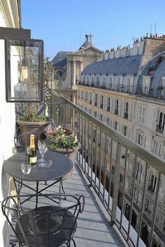 a balcony with tables and chairs on it