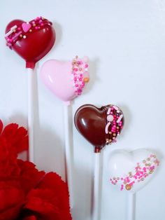 three heart shaped lollipops sitting on top of each other