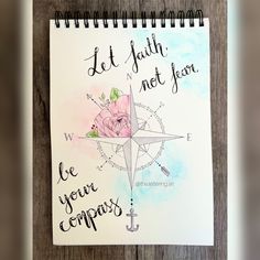 a spiral notebook with a compass and rose on the cover that says let faith not fear be your compass