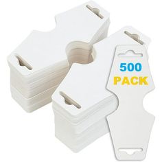 three white plastic tags with the words 500 on them