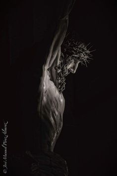 black and white photograph of a naked woman in the dark with her arms stretched out