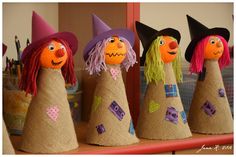 three scarecrows with hats and hair are sitting on a shelf in front of a mirror