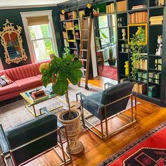 a living room filled with lots of furniture and bookshelves